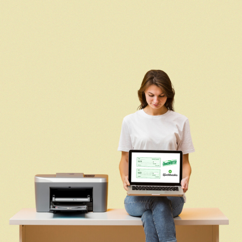 QuickBooks check printing A Woman Sitting at a Desk with a Laptop and Printer, Using QuickBooks Check Printing