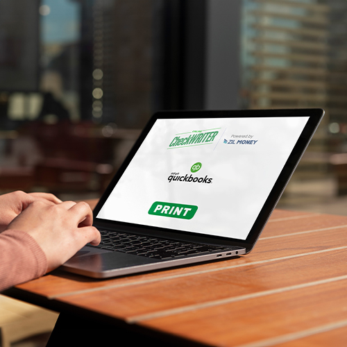 QuickBooks Online Check Printing – Customize And Print Easily A Man Typing on a Laptop. QuickBooks Online Check Printing Isn't Impossible. He Is Easily Import and Print His Checks Online