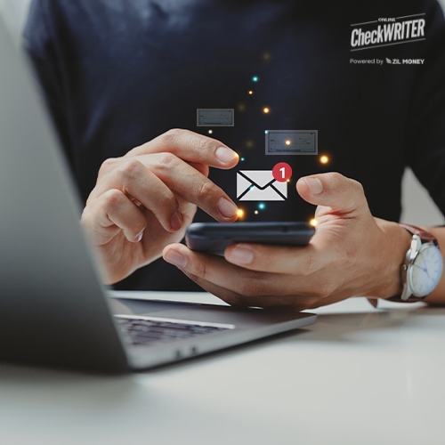 Aman Holding a Smartphone Processing Bulk Check Mailing Using The All In One Check Printing Platform