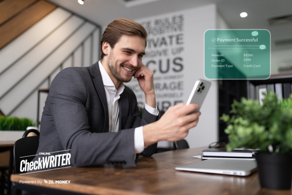 A Man Using A Mobile To Make Bulk Payment Using The Platform