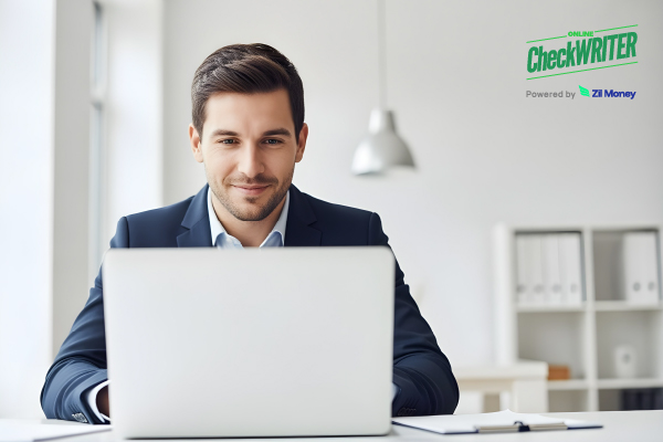 Bulk Payments Being Reviewed by a Business Professional on a Laptop in a Modern Office, Showing a Simple Way to Send Money to Multiple People at Once.