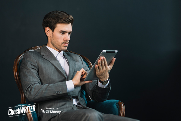 Request Payment Process Being Managed by a Young Businessman in a Suit Using a Digital Tablet, Symbolizing Professional and Efficient Online Transactions.