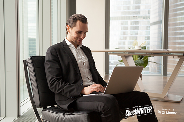 A Man Using A Laptop To Make Payments. Represents Streamline Bulk Payment with Multiple Payment Methods.