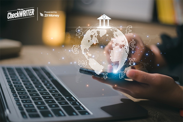 A Man Using A Laptop And Phone To Make International Payments with Fast and Secure Transactions