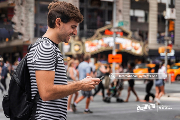 A Man Using His Phone in the City, Showing How International Payments Can Be Sent Easily Through a Mobile App.