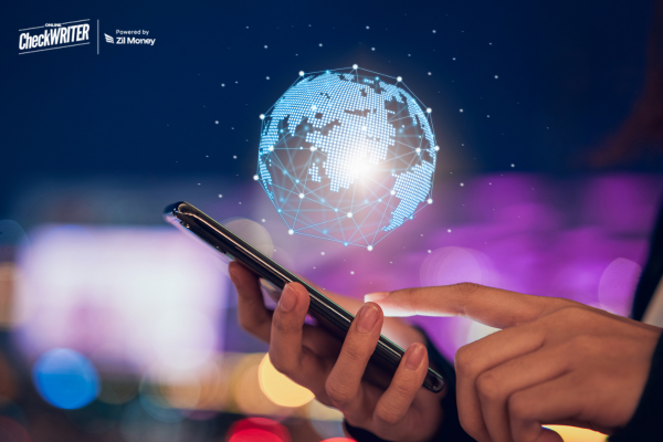 A Man Using A Mobile to Make International Payments in Minutes with Transparent Pricing, No Pre-Funding, and Multi-Currency Support—No Hassle