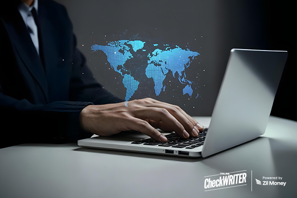 A Person Typing on a Laptop with a Glowing World Map Overlay, Highlighting the Ease and Speed of International Payments.