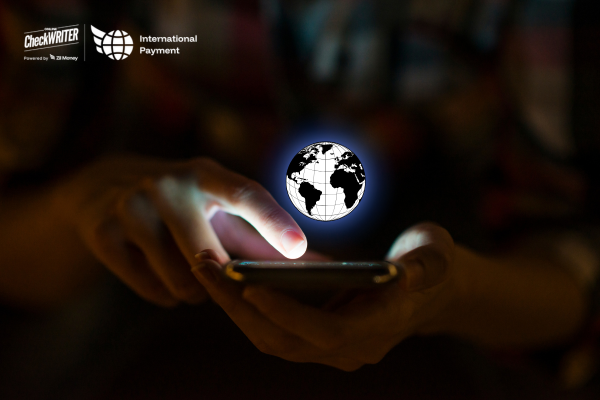 A Man Using a Mobile to Make a Payment Easily. Fast International Payments with Real-Time Exchange Rates, Low Fees & Instant Processing