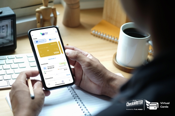 Person viewing a gold virtual card and transactions on a smartphone, showing mobile money management.