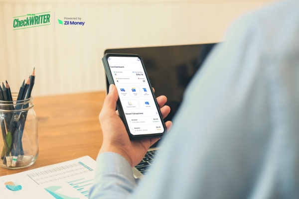 How Growing Startups Can Cut Expense Chaos with Virtual Daily Budget Cards Hands holding a smartphone that displays a finance dashboard, showing the real-time expense tracking of a Daily Budget Card.