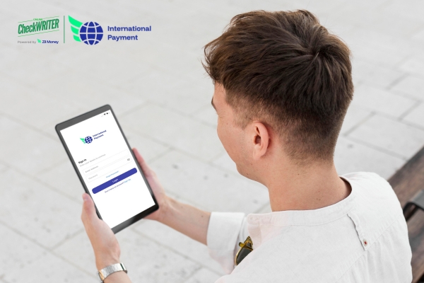 Man using a tablet to log into an app for secure international payments.
