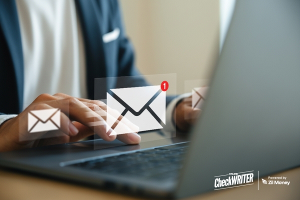 Modern Businesses, Timeless Payments How Check Mailing Got Smarter Close-up of a person typing on a laptop, with digital mail icons floating above, signifying fast, digital Check Mailing.