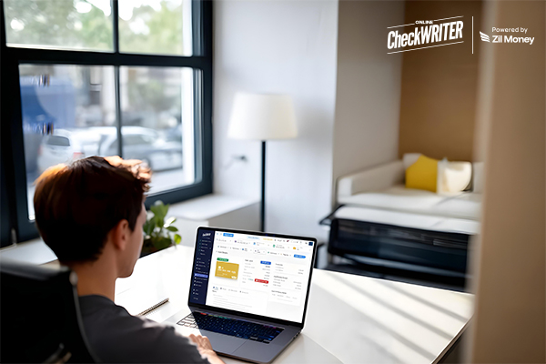 Turn Team Spending into a Growth Strategy with Expense Management Cards A young professional works on a laptop, viewing financial reports and a virtual Team Expense Management Card on the screen, emphasizing easy financial control.