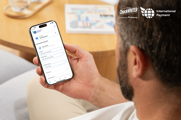 A person holds a smartphone displaying an app for making International Payments, highlighting the convenience of mobile global transfers.