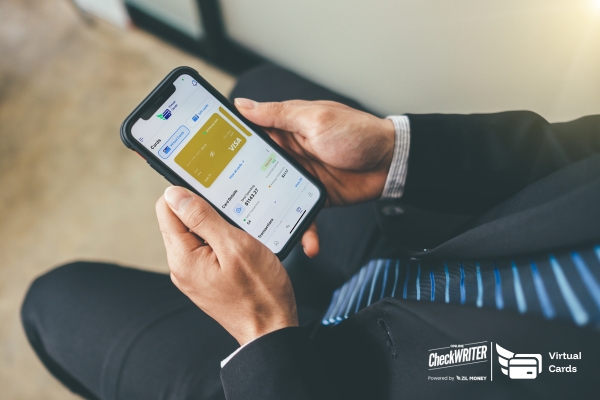 Man in a suit using a mobile app to view his Virtual Card balance and transaction details for secure and quick business payments.