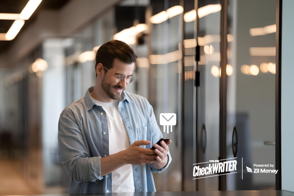 A Man Using A Laptop to Make a Payment Easily. Automate Check Mailing to Ensure Timely Payments, Avoid Late Fees, Track Deliveries, and Manage Business Finances