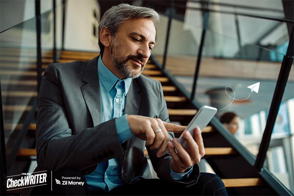 A business professional using a smartphone to send a Check Mailing request.