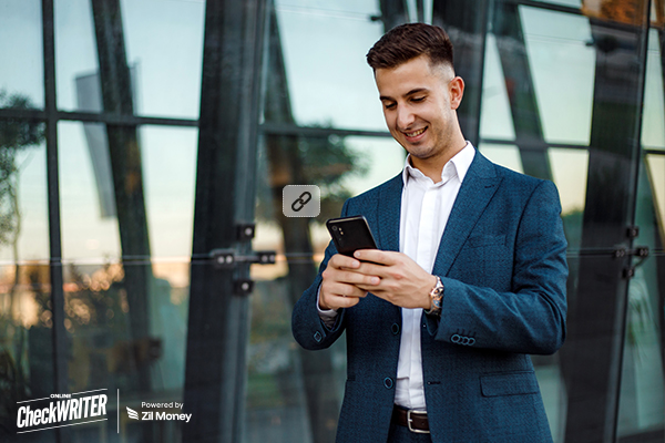 A Man Holding a Smartphone Creating and Sending Payment Links, How Payment Links Are Reinventing XPayment Collection for Freelancers